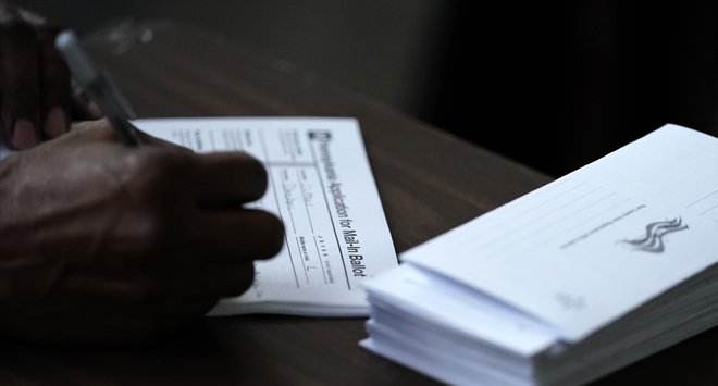 US plows ahead with mail-in voting despite ballot errors