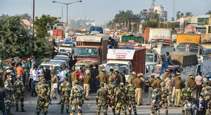Braving tear-gas shells, farmers close to Delhi
