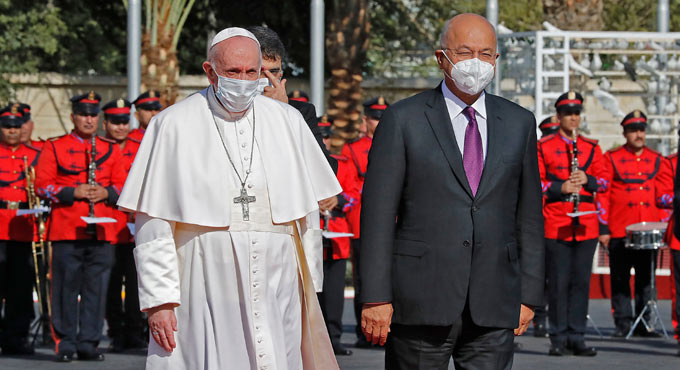 Pope Francis waves to crowds in Iraq’s capital