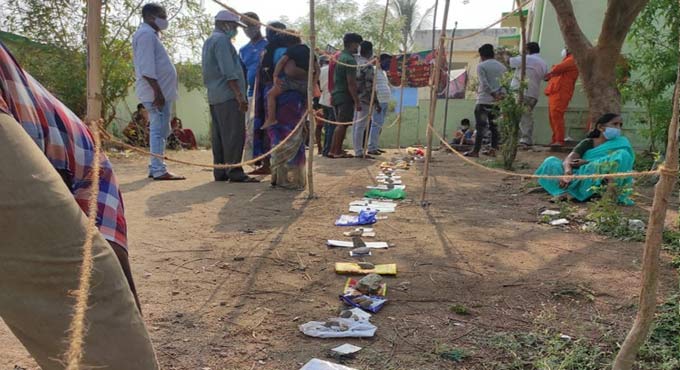 Aadhaar cards placed in queue lines for Covid test in Jagitial