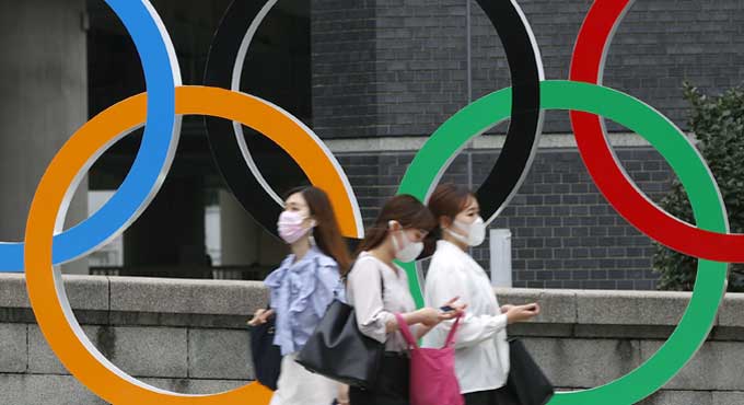 Japan to declare virus emergency lasting through Olympics