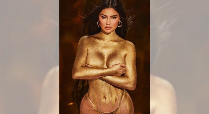 Kylie Jenner shimmers in gold dust body paint photo