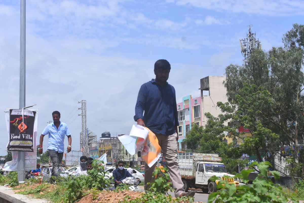 BJP workers tear up flex posters welcoming Amit Shah