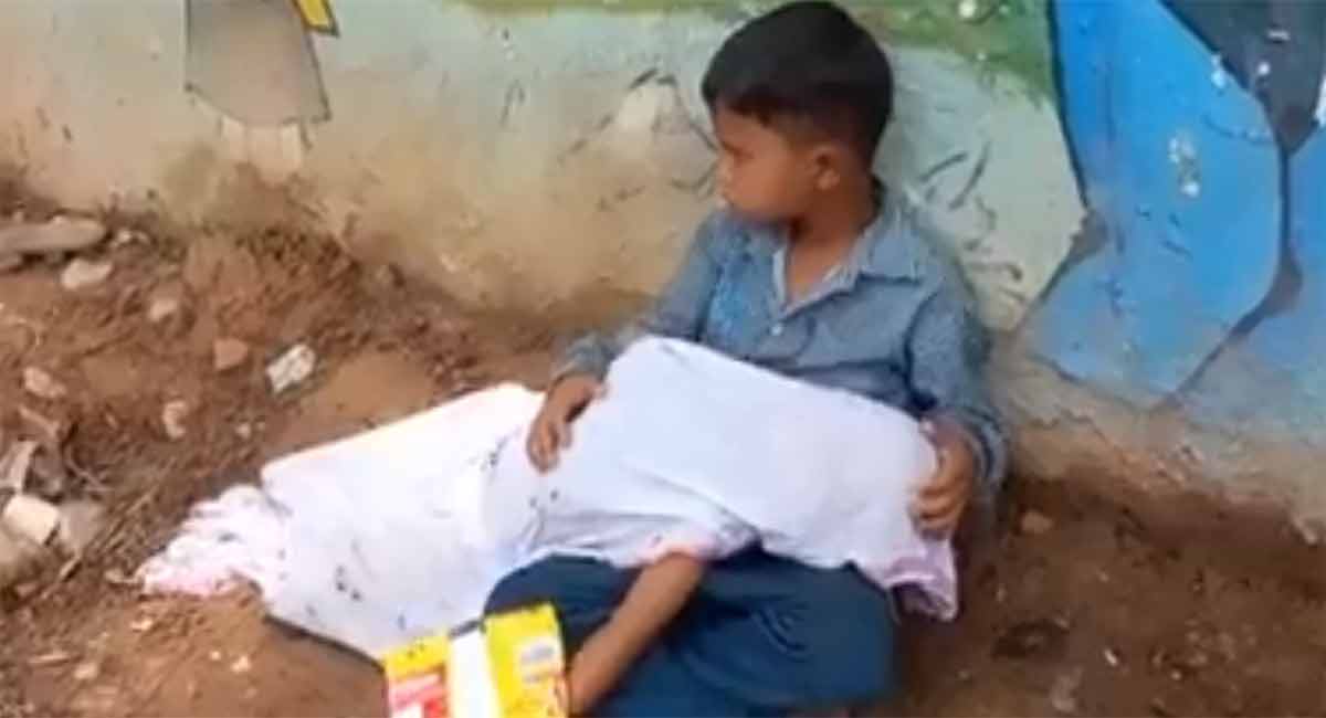 Watch: No ambulance, 8-year-old boy sits by road with body of brother