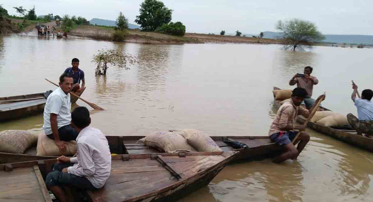 PDS rice shipped by boat to remote village isolated by floods in Mancherial
