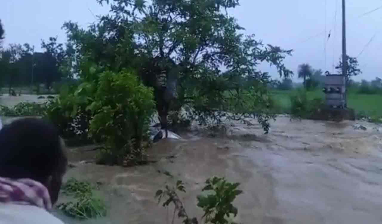 Watch: Car washed away in stream at Vikarabad, villagers rescue couple