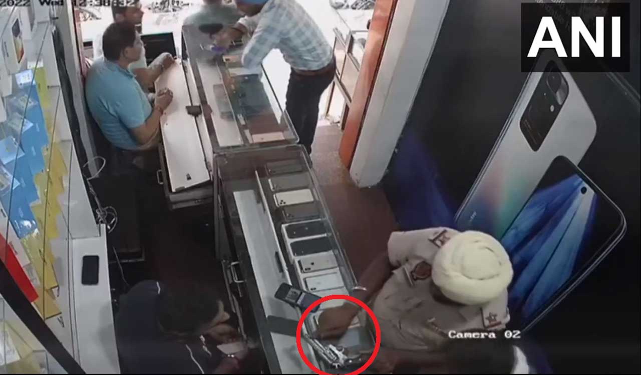Watch: Cop accidentally fires at mobile shop employee, suspended