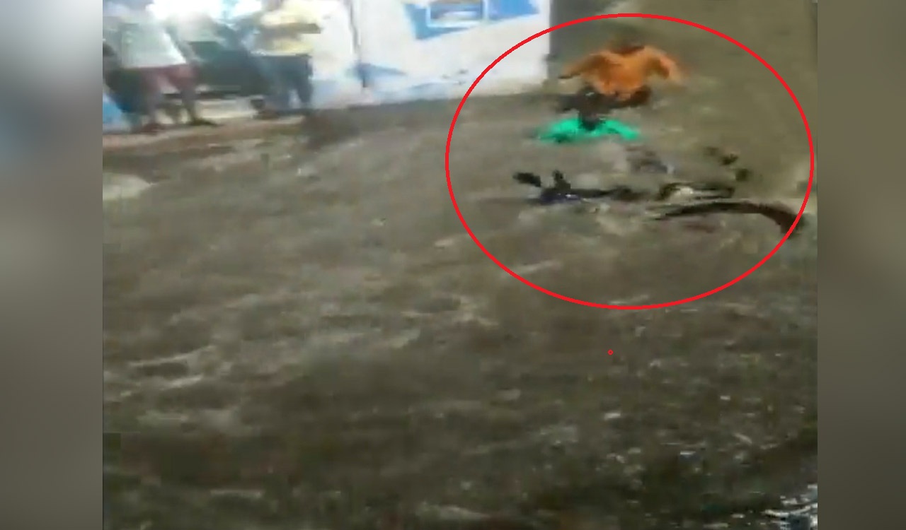 Watch: Man swept away along with two-wheeler at Borabanda