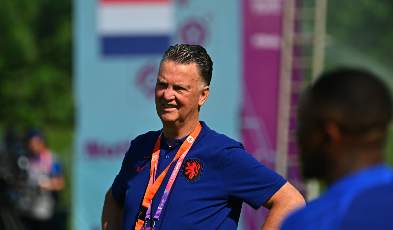 Netherlands coach Van Gaal hugs reporter at FIFA World Cup