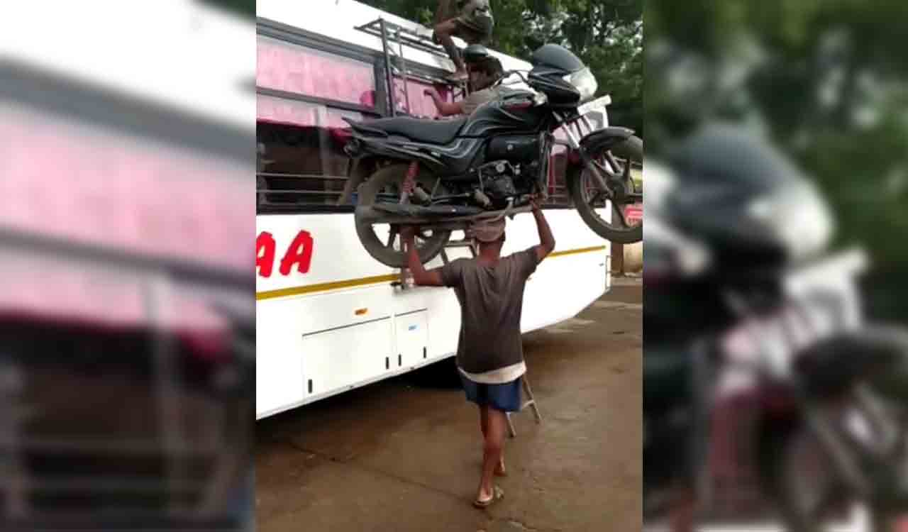 Watch: Man climbs bus ladder with bike on his head