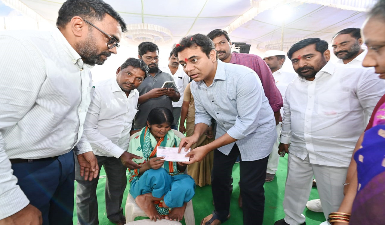 KTR hands over cheque of Rs 5 lakh to fluorosis victim Thirupathamma