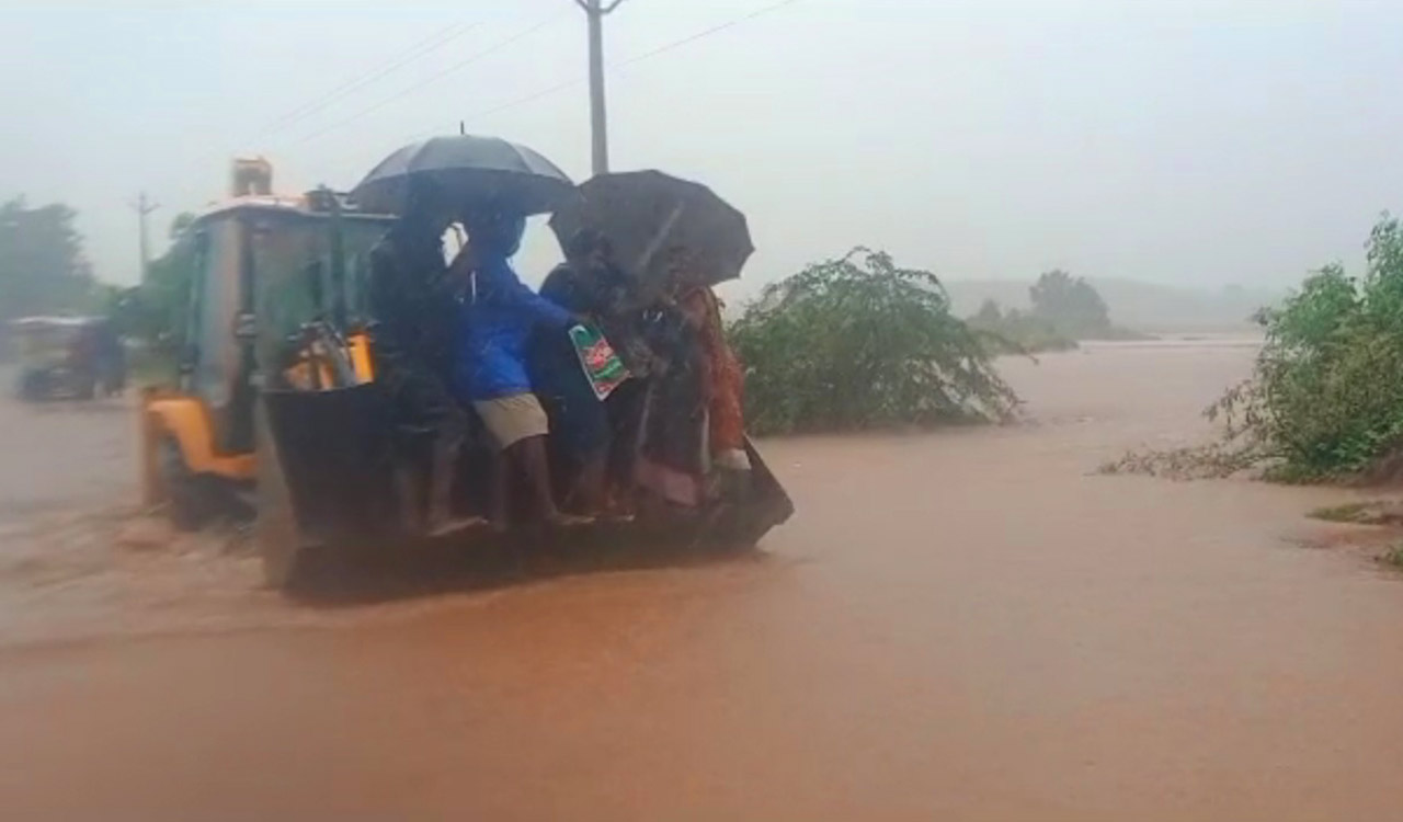 WATCH: Pregnant woman taken across flooded road on excavator in Jagtial