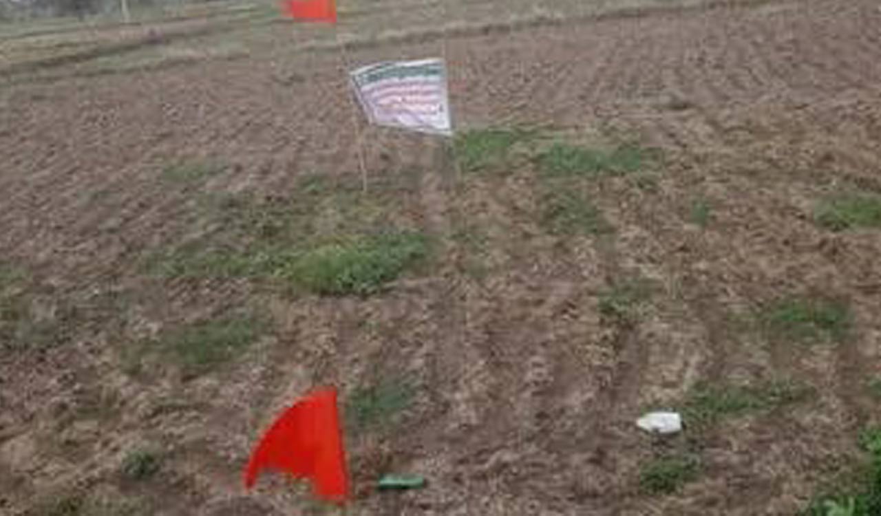 Kamareddy: Bank officials pitch red flags, use flexis to announce land auctions due to unpaid debts