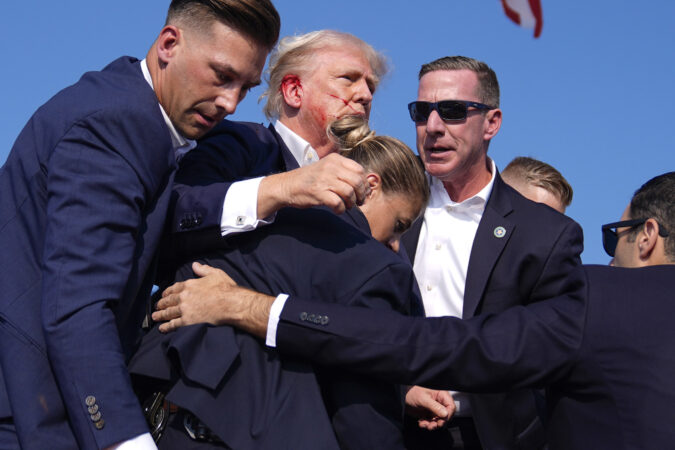 Republican presidential candidate former President Donald Trump is surrounded by U.S. Secret Service agents at a campaign rally, Saturday, July 13, 2024, in Butler, Pa. :AP Photo