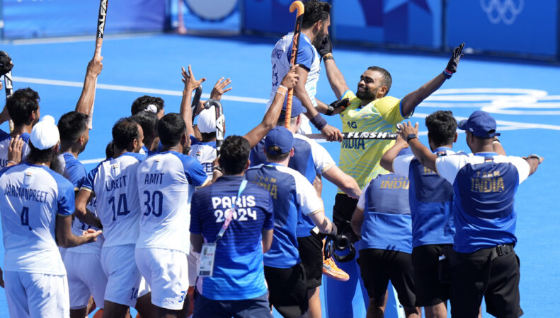 ndia's goalkeeper Parattu Reveendran Sreejesh, in yellow jersey, reacts as Indias players celebrate after winning the mens bronze medal field hockey match against Spain at the Yves-du-Manoir Stadium during the 2024 Summer Olympics, Thursday, Aug. 8, 2024, in Colombes, France.