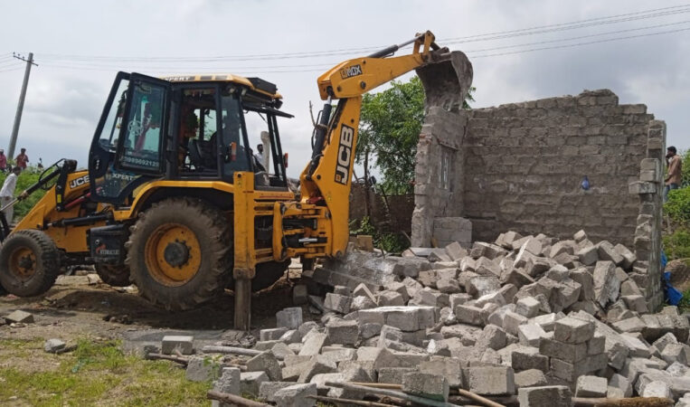 Ramagundam municipal staff demolishing houses near Ganganagar of Godavarikhani town.