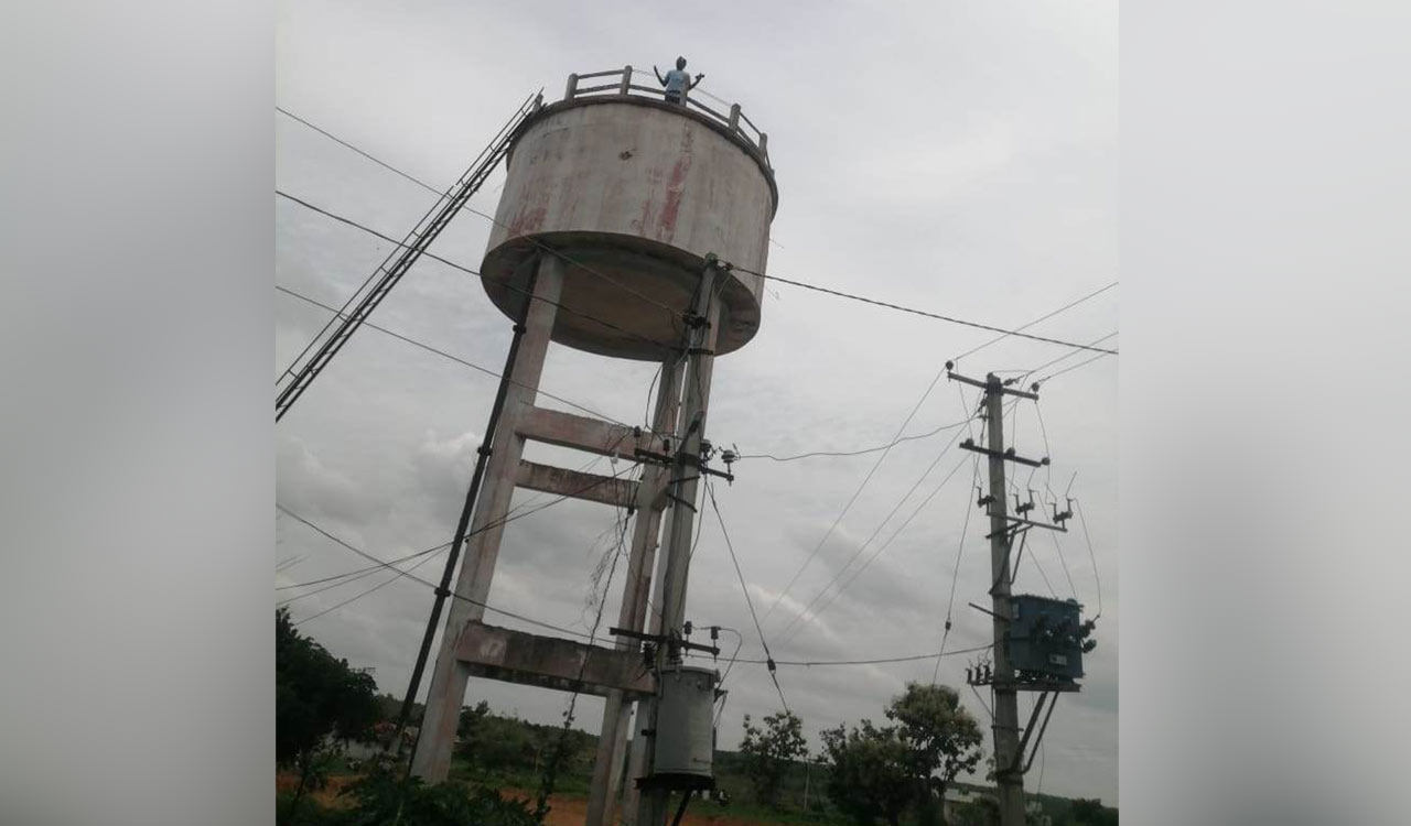 Man climbs water tank to protest over blocking of road in Medak