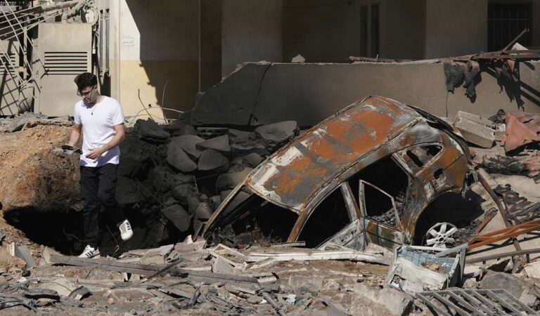 A Man Walks On Rubble At Th