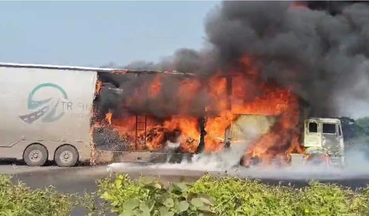 Container lorry with cars catches fire on NH-65 at Zaheerabad