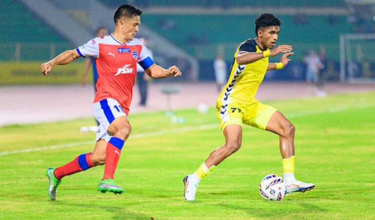 HFC's Abdul Rabeeh (right) and BFC's Sunil Chhetri vie for the ball in Hyderabad, on Saturday.