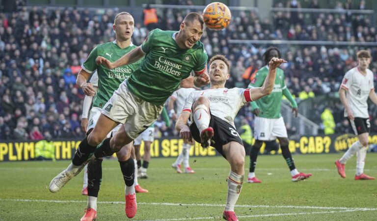 Plymouth Argyles Nikola Katic (left) clears the ball next to Liverpool’s Diogo Jota during the English FA Cup fourth round match at Home Park stadium in Plymouth, on Sunday. Photo: AP