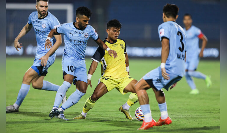 Hyderabad’s Ramhlunchhunga dribbling with the ball against Mumbai’s Jon Toral, Brandon Fernandes and Valpuia in Hyderabad on Wednesday.