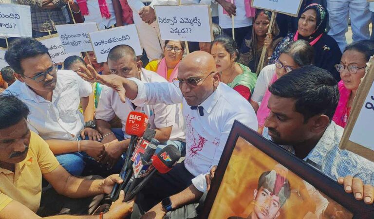 BRS leader Dr RS Praveen Kumar takes part in a protest demanding a broad bridge near Easgaon village in Kagaznagar mandal on Monday