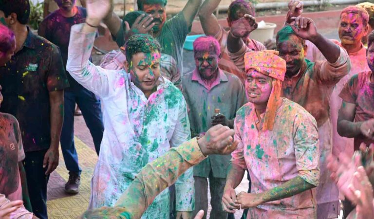 Collector Rajarshi Shah and SP Akhil Mahajan dance to drum beats to mark Holi festival in Adilabad on Friday