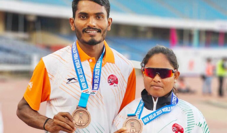 Visually challenged athlete C K Lalitha, who won gold in the 400m event in World Para Athletics Grand Prix in Delhi, with her 'guide runner' Tabres Khan.