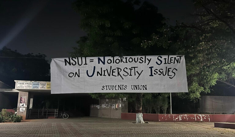The banners directly targeted the State government’s move to auction university land for corporate purposes.