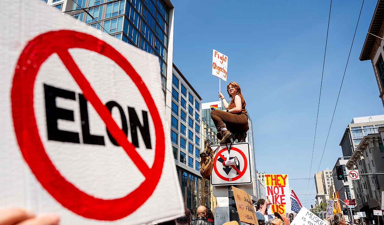 Protests against Elon Musk’s purge of US government swarm Tesla showrooms