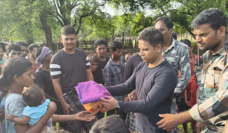 ASP Vikrant Kumar Singh distributing clothes to adivasis of Chennapuram in Cherla mandal.