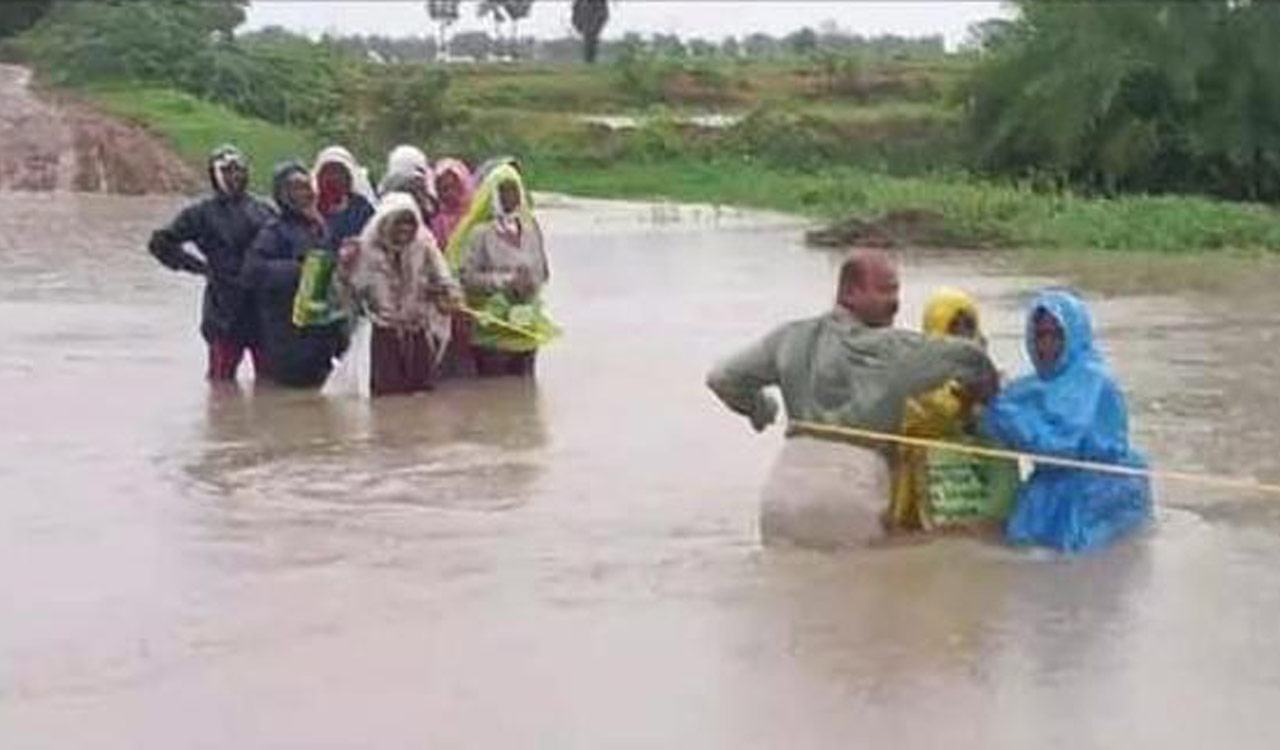 15 women labourers stranded in flooded rivulet rescued by locals in Peddapalli
