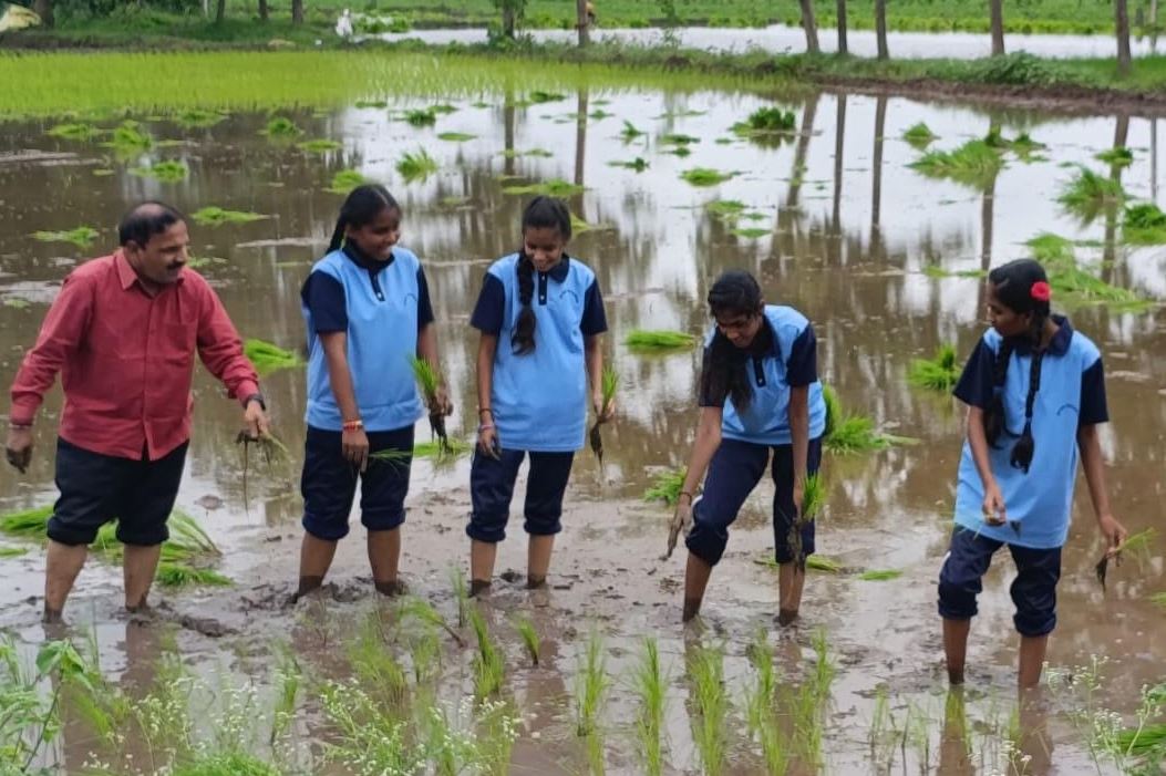 ZPHS students get hands-on experience in paddy planting in Karimnagar
