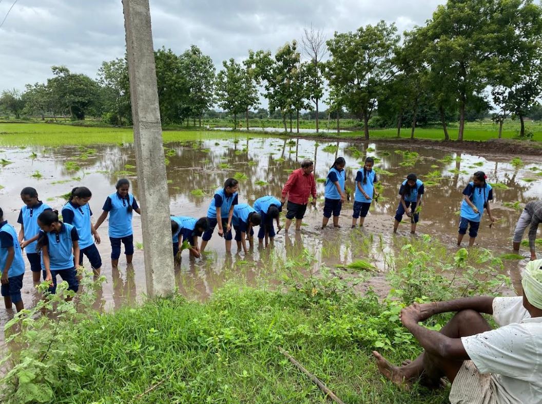 ZPHS students get hands-on experience in paddy planting in Karimnagar