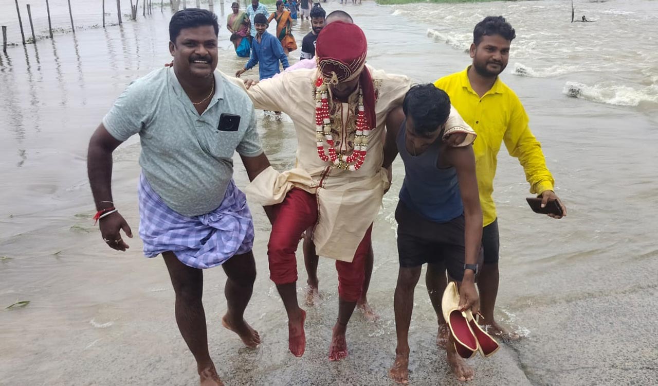 Bridegroom carried on shoulders to cross flooded culvert in Karimnagar