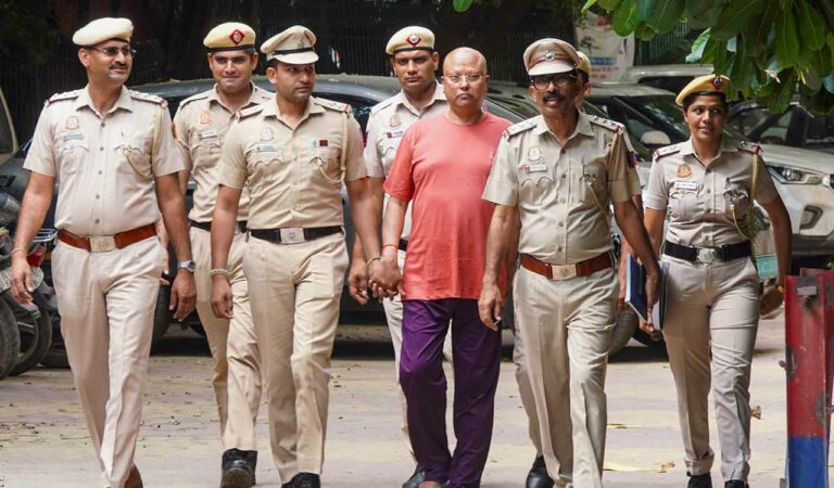 Self-styled godman Chaitanyananda Saraswati, who allegedly sexually harassed 17 women students at a private institute in Agra, being escorted by police personnel after his arrest, at Vasant Kunj police station, in New Delhi.