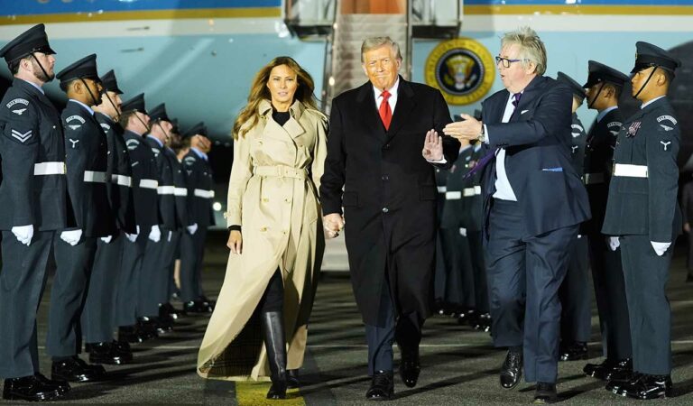 President Donald Trump and first lady Melania Trump are greeted by The Viscount Hood, Lord-in-Waiting, center, right, as they arrive at Stansted Airport near London