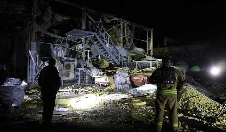 Rescuers work near a destroyed supermarket after a Russian drone strike in Zaporizhzhia, Ukraine.