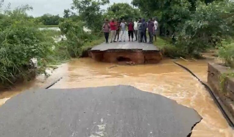 Heavy rains in Sangareddy’s Saidapur village washed away a key road linking Vikarabad and Sangareddy, disrupting traffic. Over 40 acres of crops were damaged, prompting MLA Chintha Prabhakar to demand compensation for farmers.