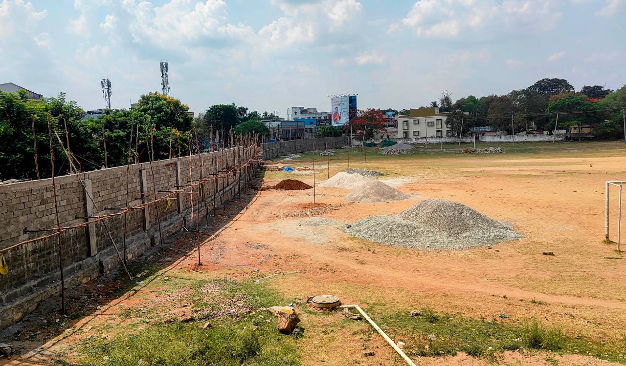 Trimulgherry football ground enclosed with high-rise wall amid corridor works
