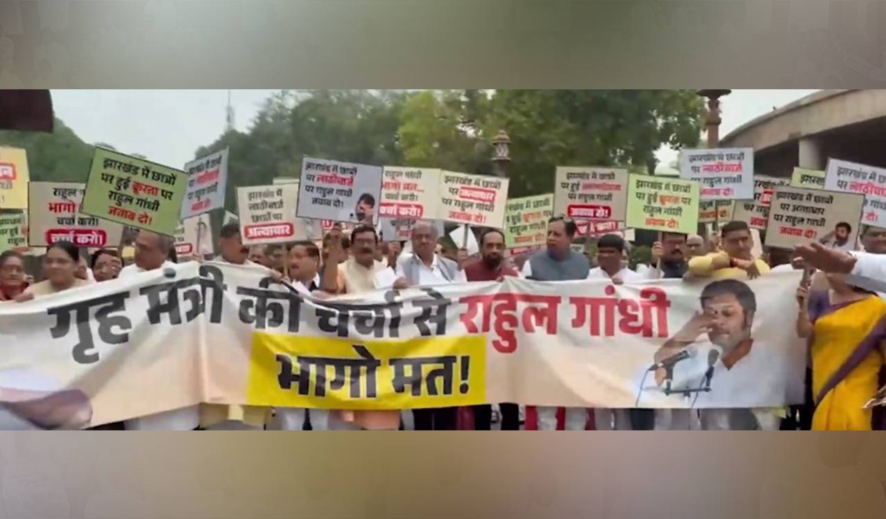 Waving ‘Rahul Gandhi bhago mat’ posters, NDA MPs stage protest march in Parliament premises