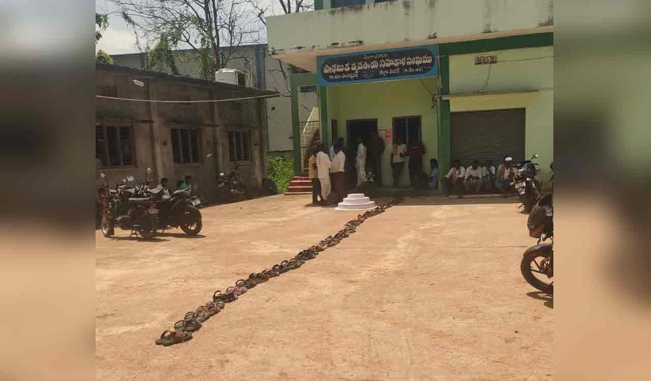 Farmers place chappal in queue for their turn to collect urea in Papannapet